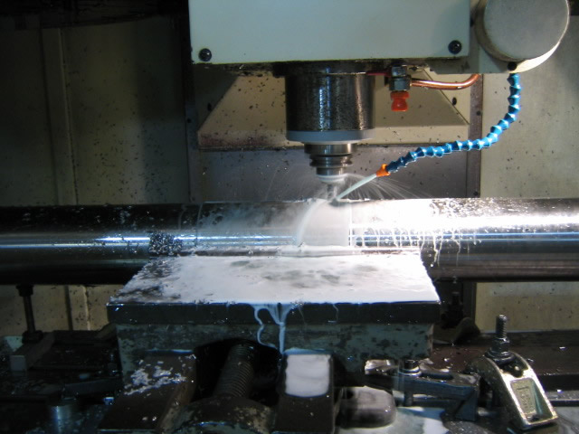 A new pump shaft being milled in a CNC milling machine.